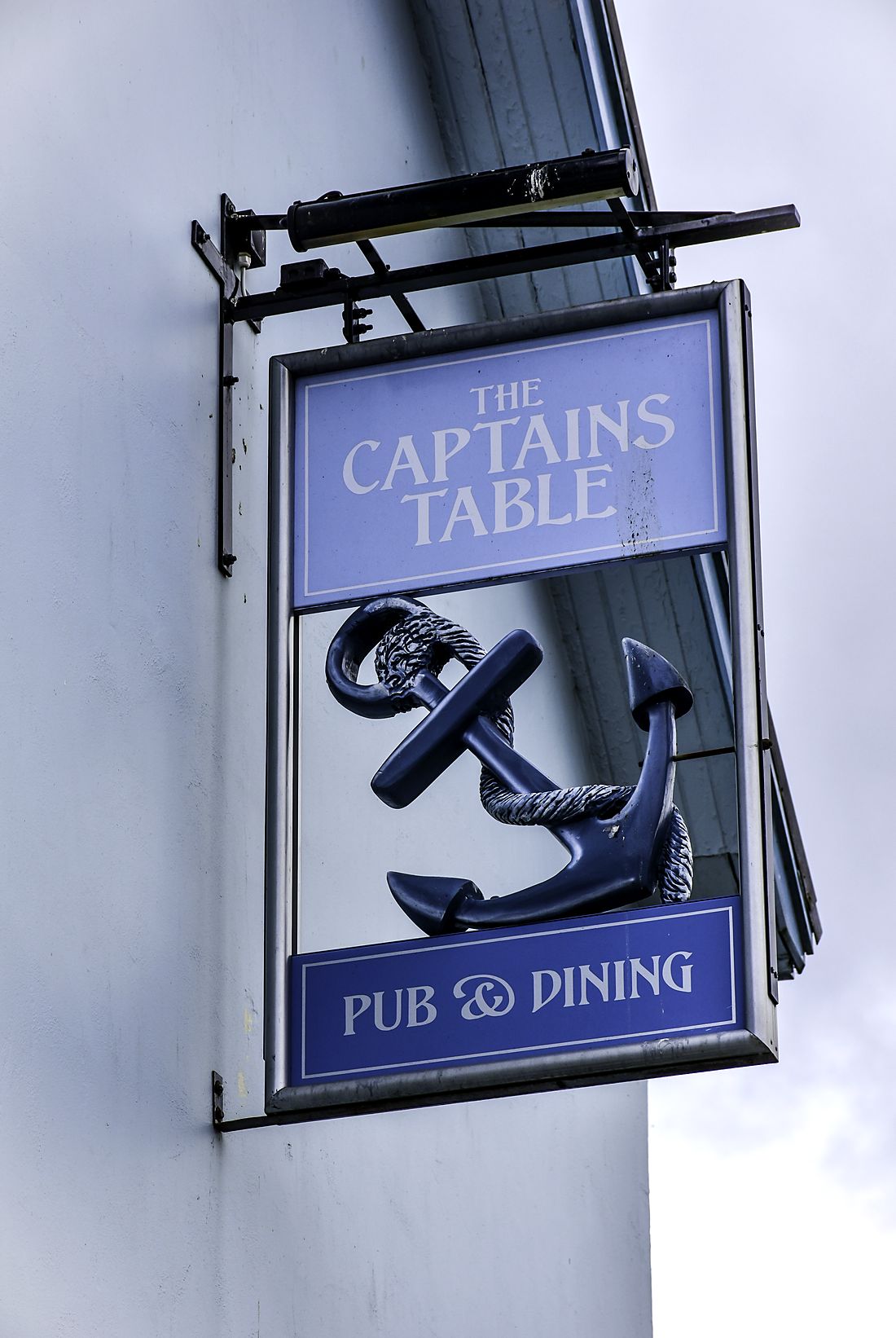 The Captains Table hanging pub sign on St Issell's House, Saundersfoot