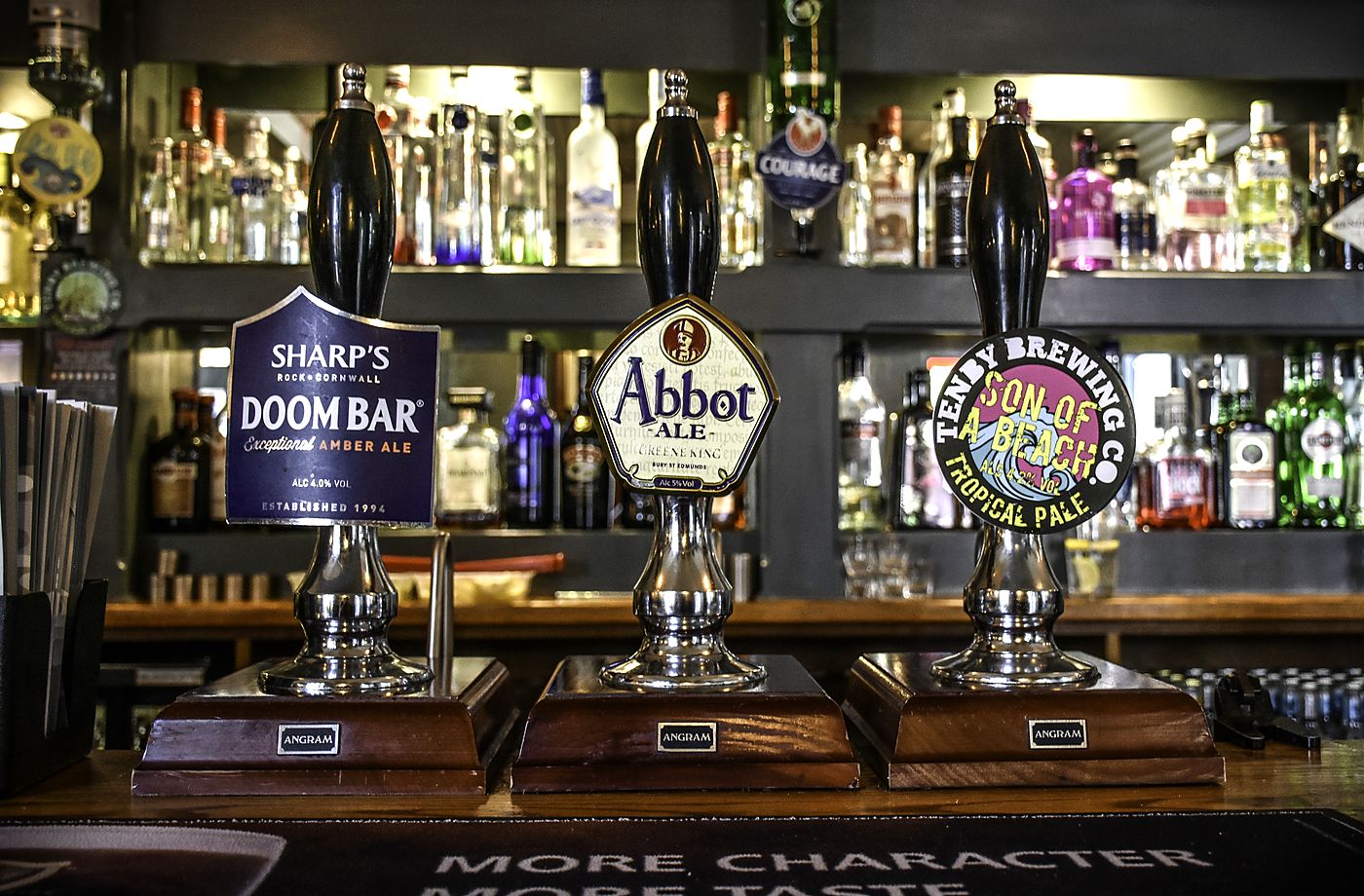 Real ale hand pumps at the Captains Table bar, including Tenby Brewing Co